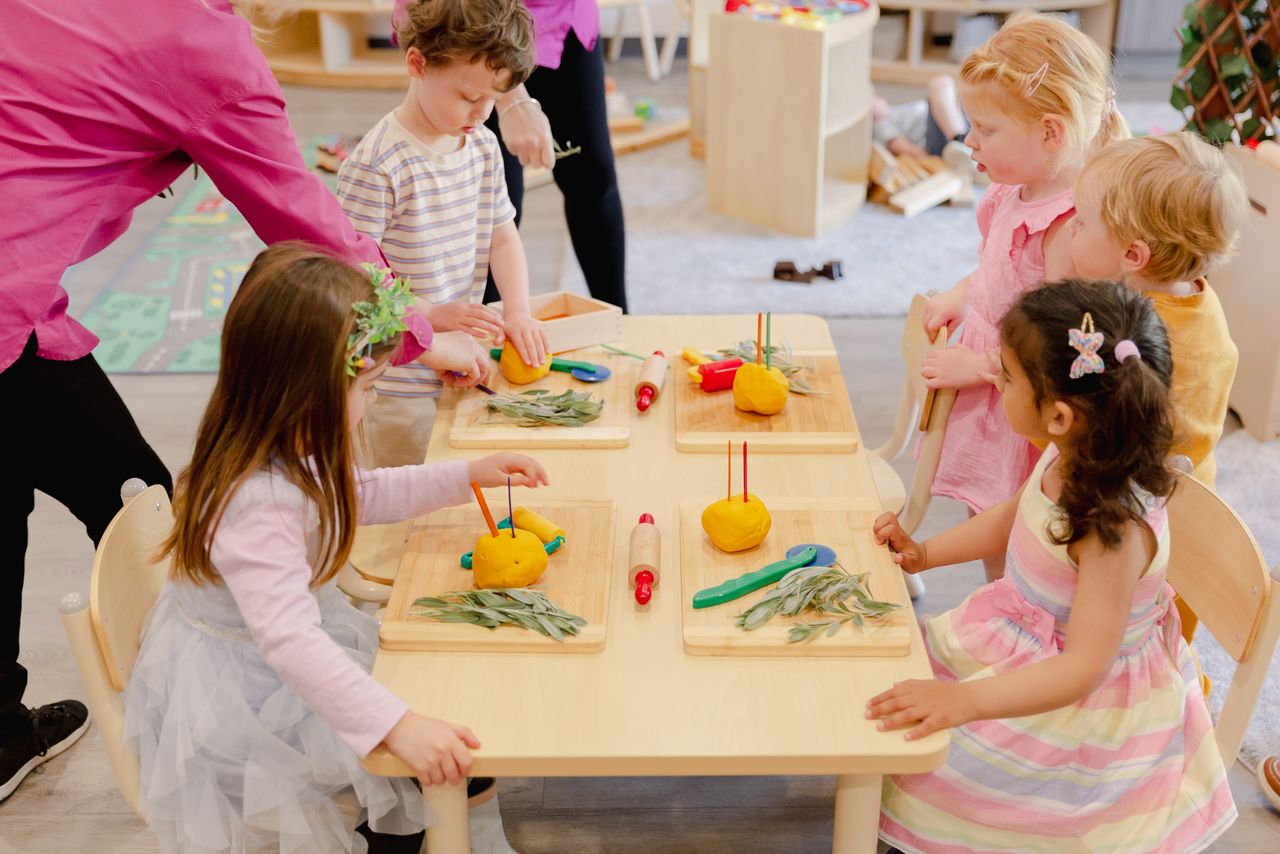 Children enjoying outdoor play and learning activities at a childcare centre Adelaide, featuring natural gardens and engaging childcare, child care, and daycare environment